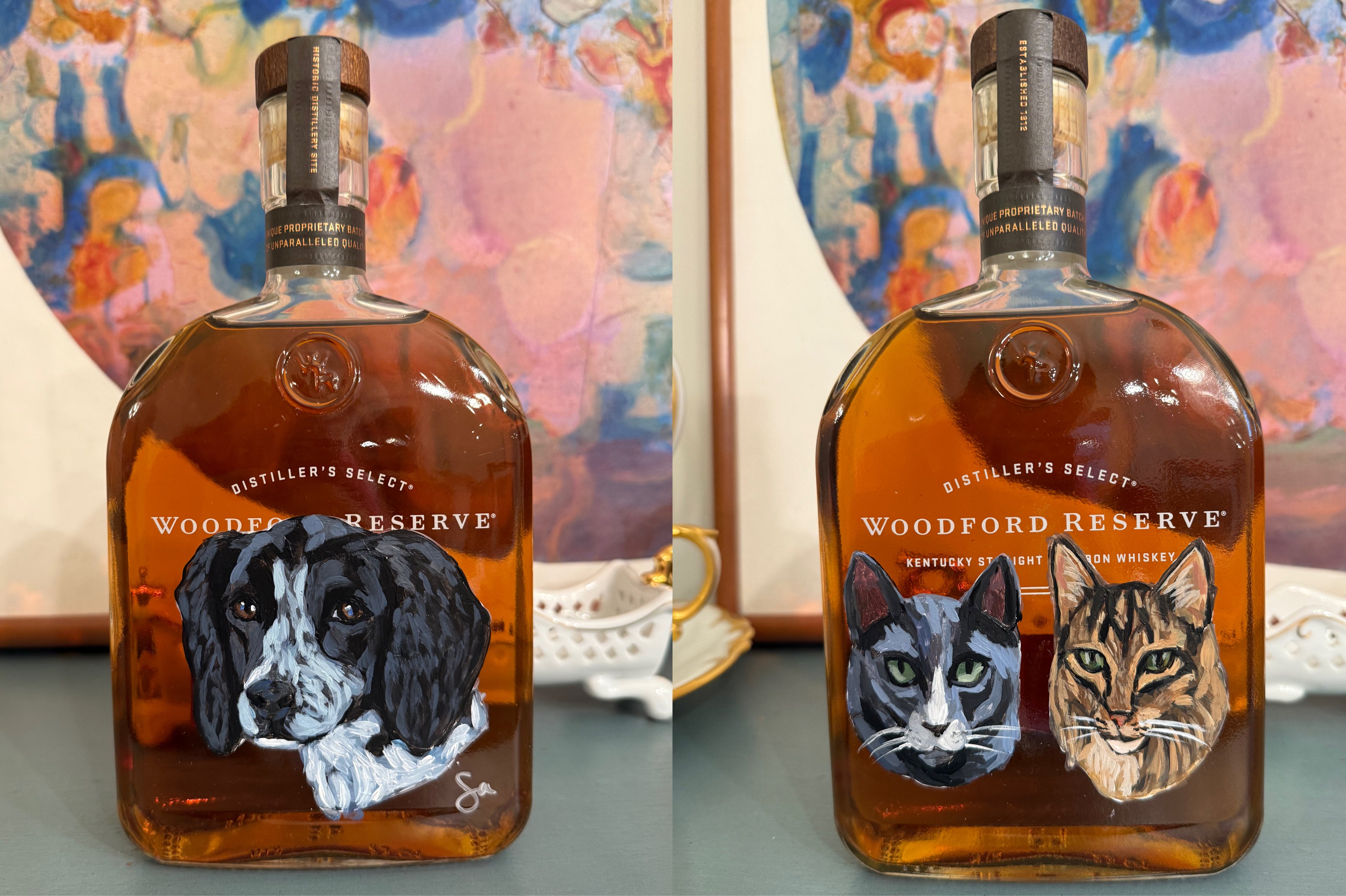 Two Woodford Reserve bottles with animal portraits on a decorative surface.